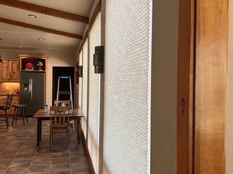 Rustic kitchen showcasing honeycomb shades